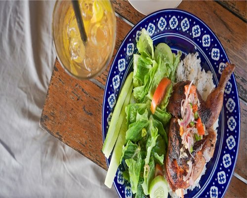 A freshly prepared home cooked plate featuring moderate portions of rice, beans, and fresh salad